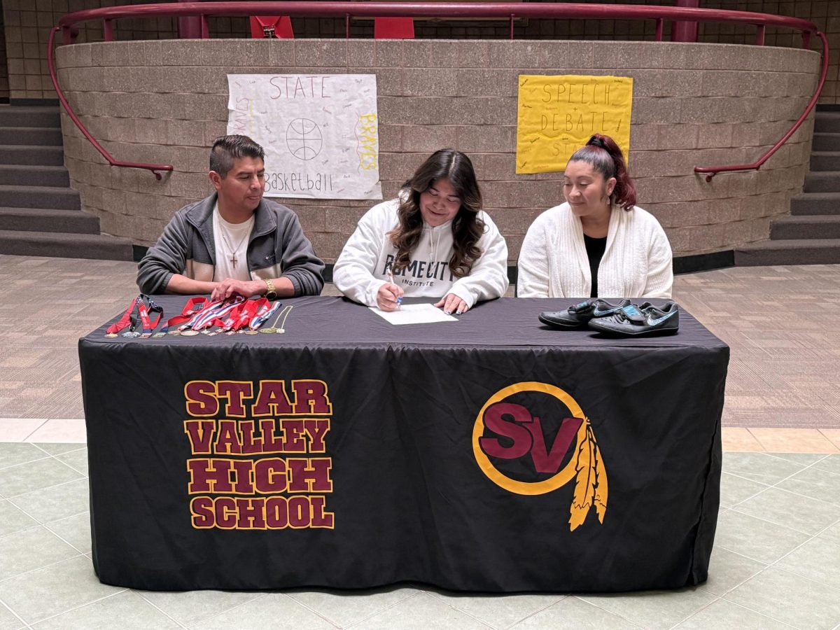 Abi's parents look proudly on as she signs her commitment to join the track team in Rome at the Rome City Institute. 
"Having my parents there was very special for me because they have supported me from the beginning," she said. 