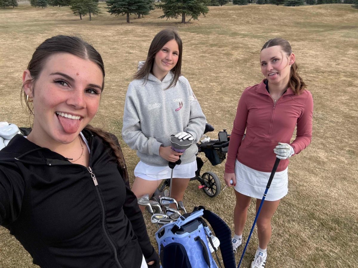 Sophomore Averie Rivard, and juniors Paylan Merritt and Presley Frome pause for a selfie during spring golf practice. “It’s fun to take a little break and capture the moment while we’re out on the course,” said Frome. The team is focused on improving both individual skills and teamwork as they prepare for the season’s upcoming meets.