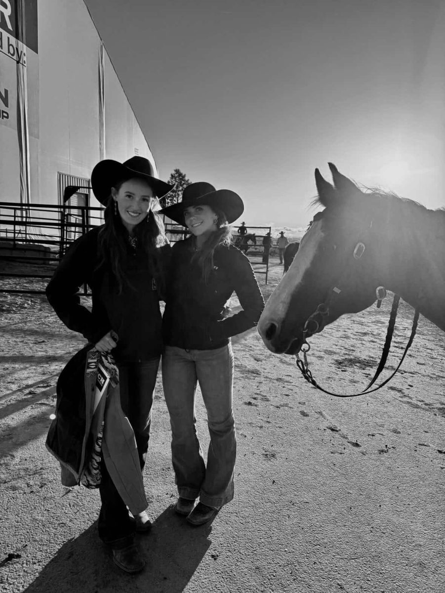 Gracie Jackson (left) and Arie Kilroy (right) pose with their horse at the spring rodeo in Pocatello, Idaho. Kilroy said, "I love the friendships that high school rodeo brings." Both seniors are competing in their last high school rodeo season, bringing experience, determination, and a love for the sport.
