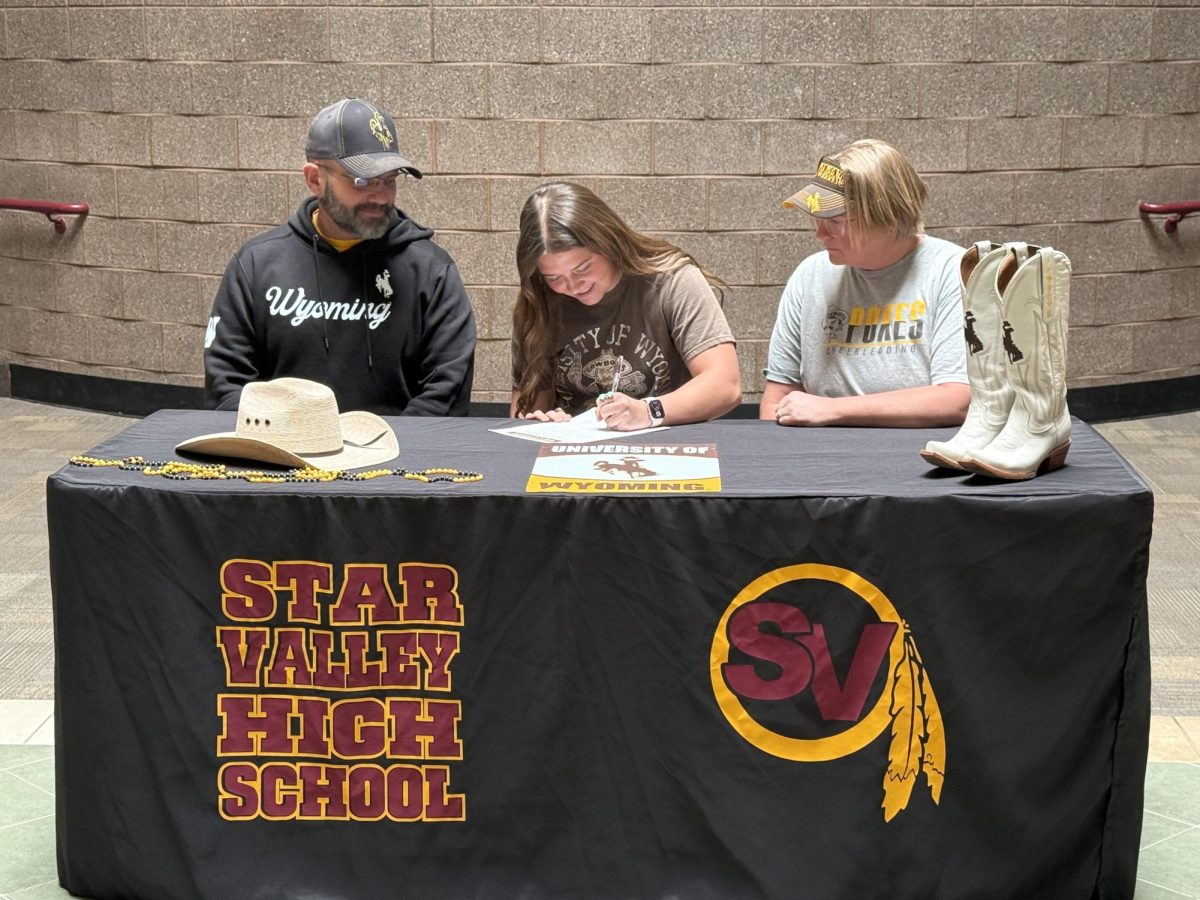 Cheerleader Harper Sessions signs with the University of Wyoming to continue her academic and cheer career at the collegiate level.